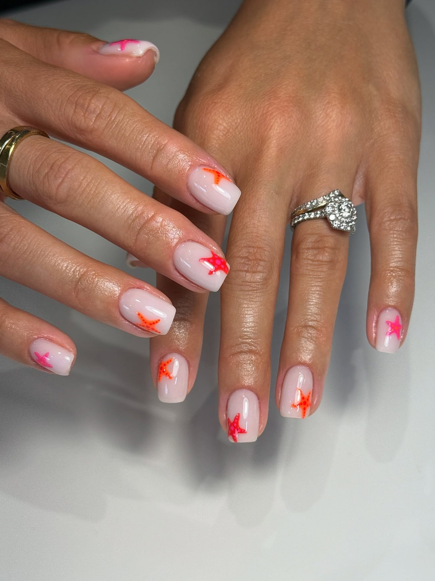 Sheer White Nails with Neon Orange and Pink Starfish