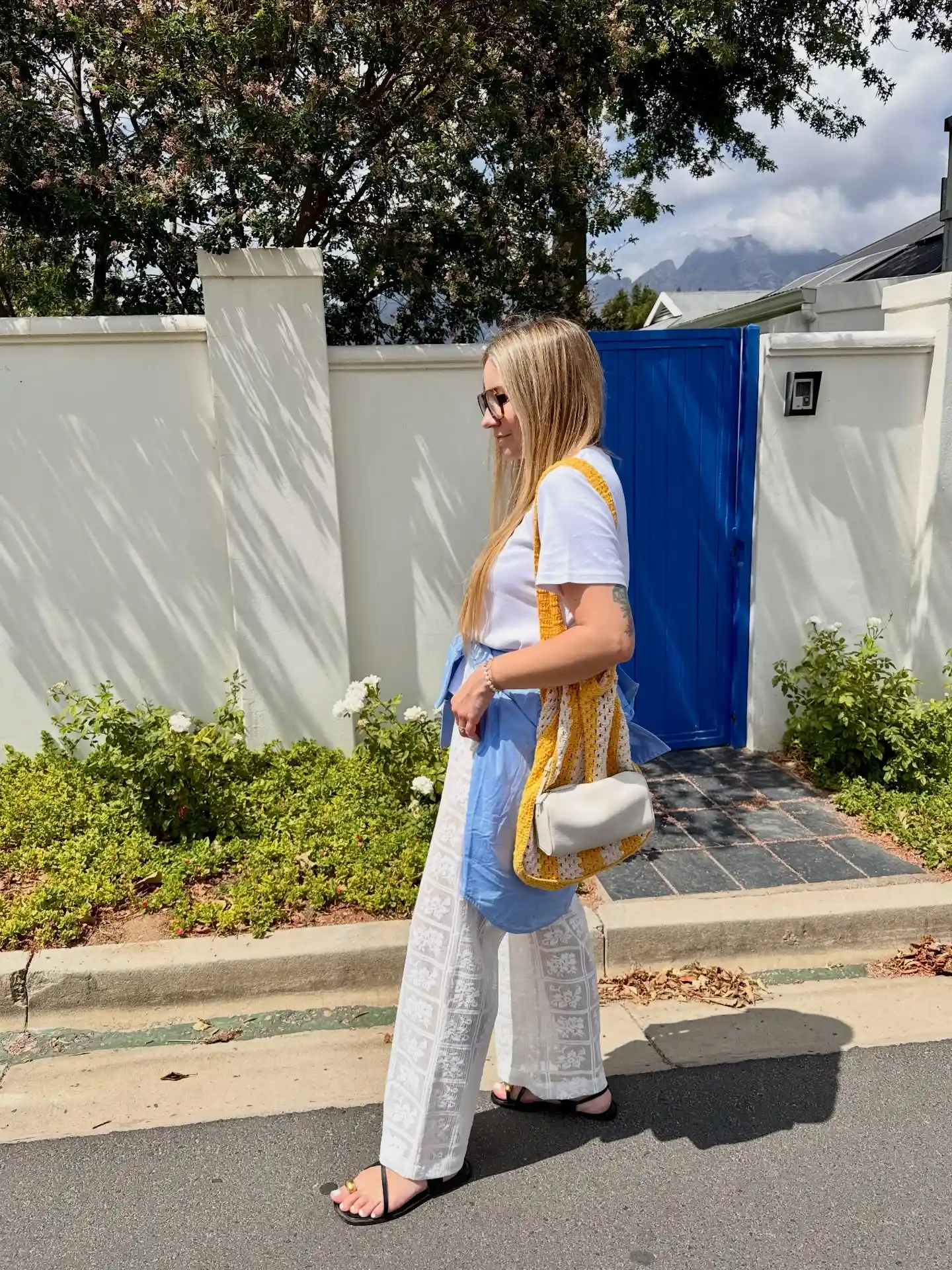 White Tee with Blue Pants and Crochet Vest
